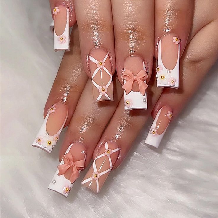 Whimsical Sophistication: Elegant Long Squared Nail Design with Floral Embellishments and Bows in Soft White and Nude Palette.