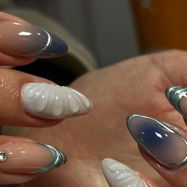 Sophisticated Ombre Nail Design with Intricate Detailing and Silver Tips.