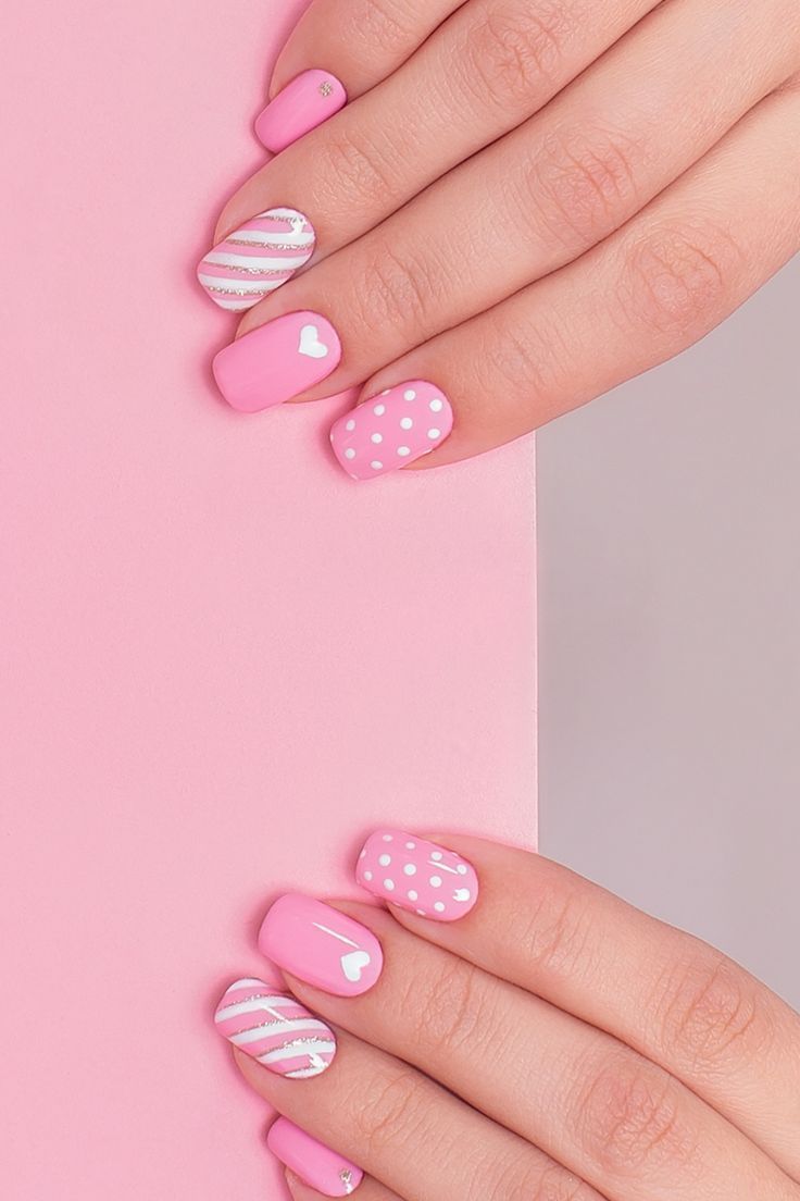 Playful Pink Nail Design with Charming Patterns and Heart Motifs