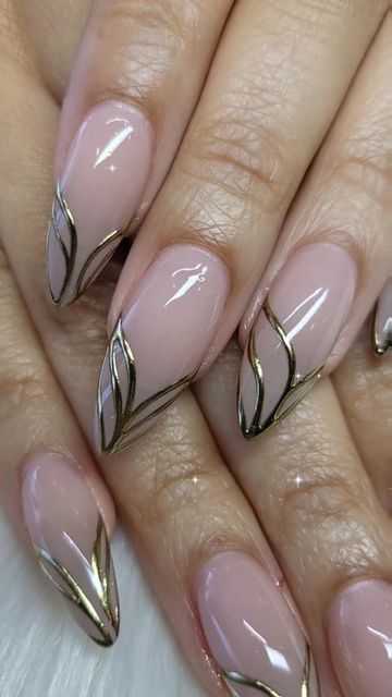 Chic Elegant Nude Nail Design with Intricate Gold Accents and Pointed Tips.