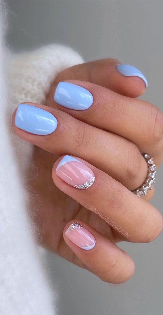 Charming Pastel Nail Design: A Trendy Blend of Soft Blue and Pink with Elegant Geometric Patterns and Glitter Accents.