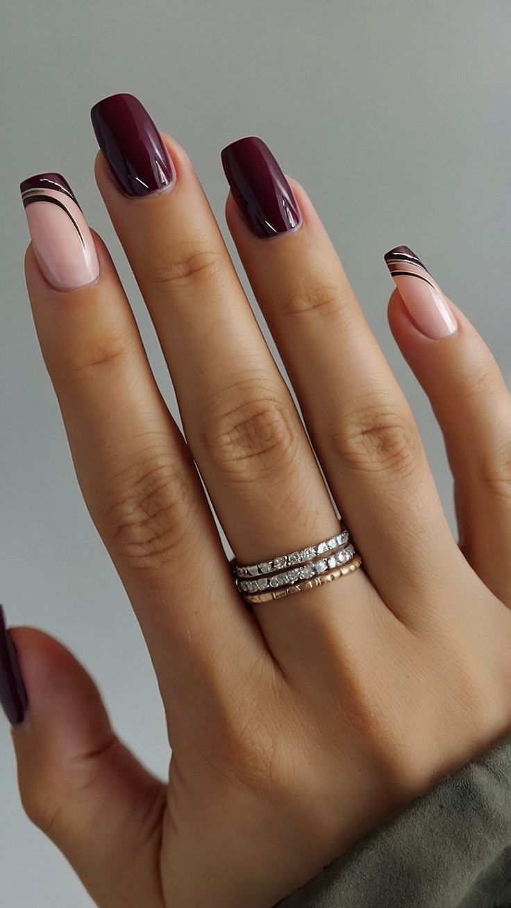 Chic Burgundy and Nude Nail Design with Gold Accents for Any Occasion