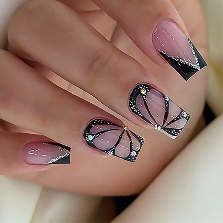 Sophisticated Soft Pink and Bold Black Nail Design with Rhinestone Embellishments.