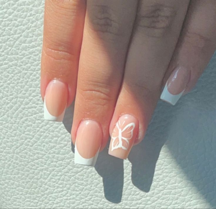 Elegant Nude and White Nail Design with Whimsical Butterfly Accent.