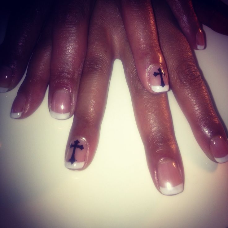 Chic Modern French Manicure with Delicate Black Cross Motifs on Nude Base.