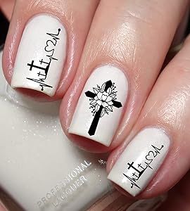 Chic Minimalist Nail Design: White Base with Intricate Black Patterns and Artistic Floral Cross Elements.