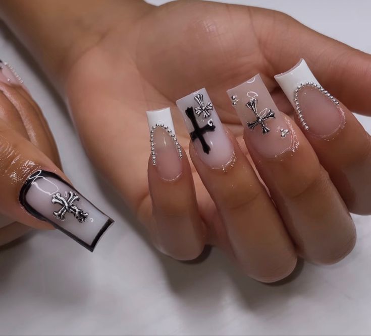 Sophisticated Nail Design: Clear and Glossy White with Black Crosses and Silver Accents