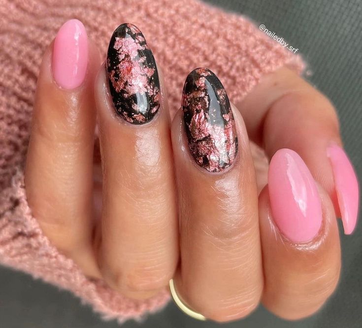 Elegant Modern Nail Design: Soft Pastel Pink Meets Bold Black with Rose Gold Flakes.