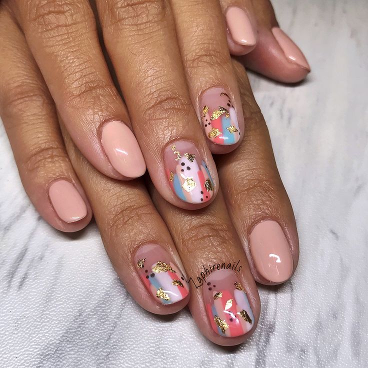 Chic Seasonal Nail Design: Soft Nude Base with Playful Colorful Accents and Shimmering Gold Details.