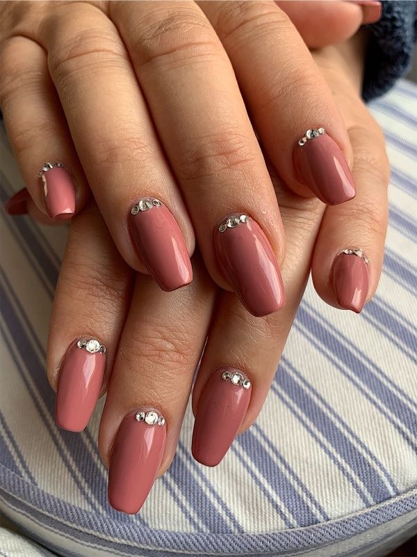 Sophisticated Muted Pink Nail Design with Delicate Rhinestone Accents