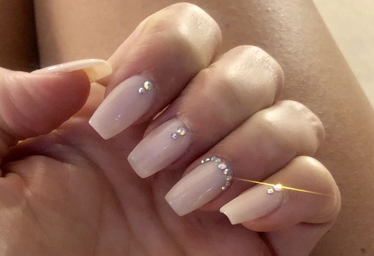 Chic Elegant Nude Nails Enhanced with Sparkling Rhinestones for Any Occasion.