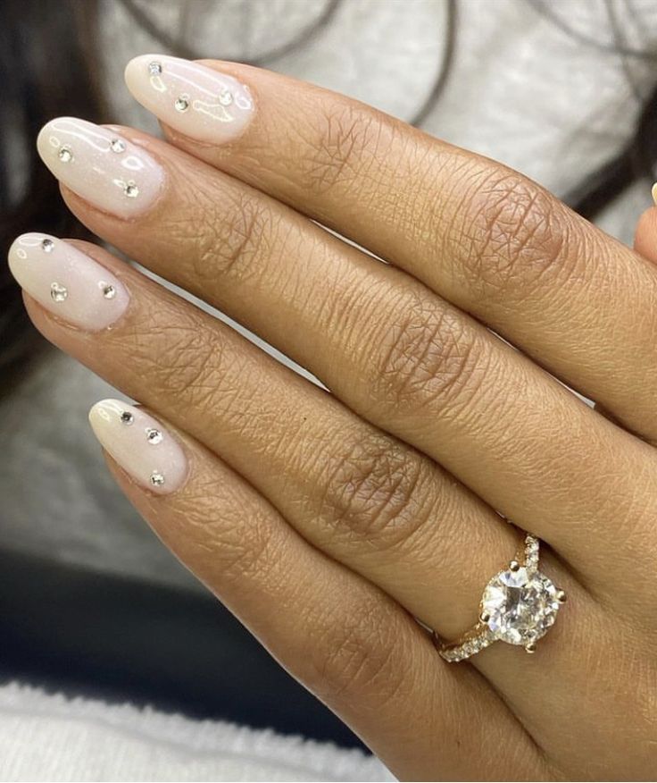 Sophisticated Elegant Nude Nail Design with Delicate Silver Accents and Sparkling Gems.