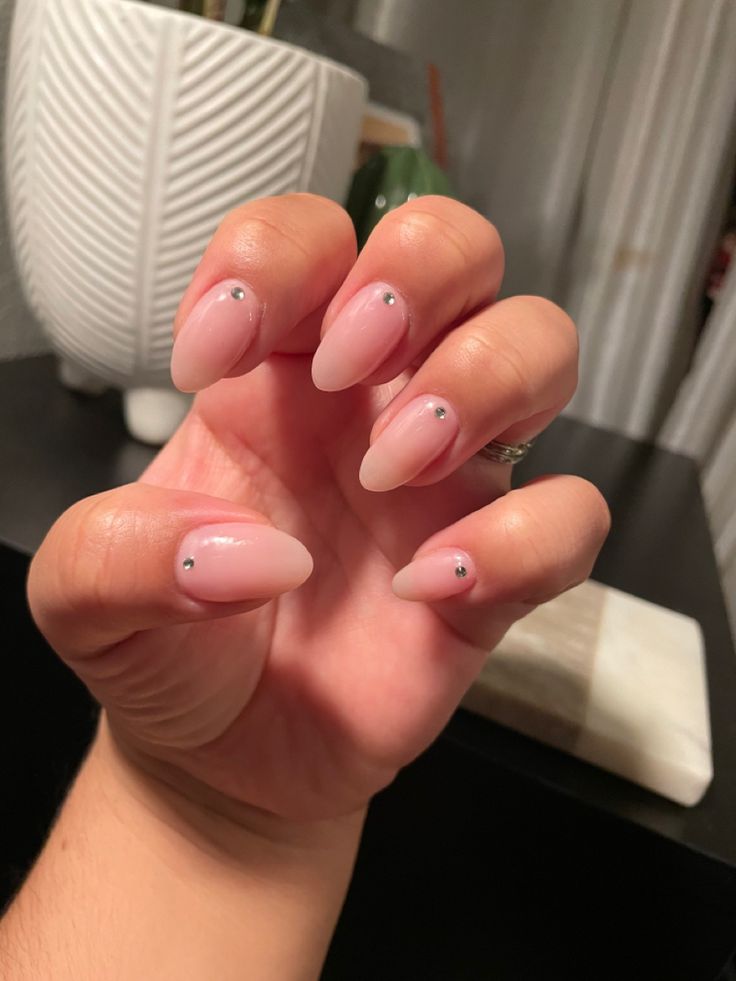 Elegant Ombre Almond-Shaped Nails with Subtle Metallic Accents.