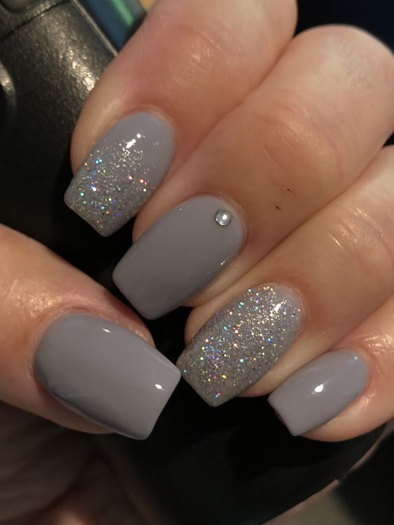 Chic Gray Nail Design with Glittery Accents and Rhinestone Elegance