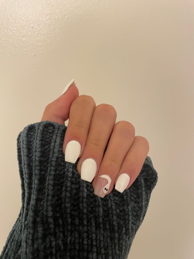 Chic Half-Moon Nail Design with White Polish and Cozy Accents