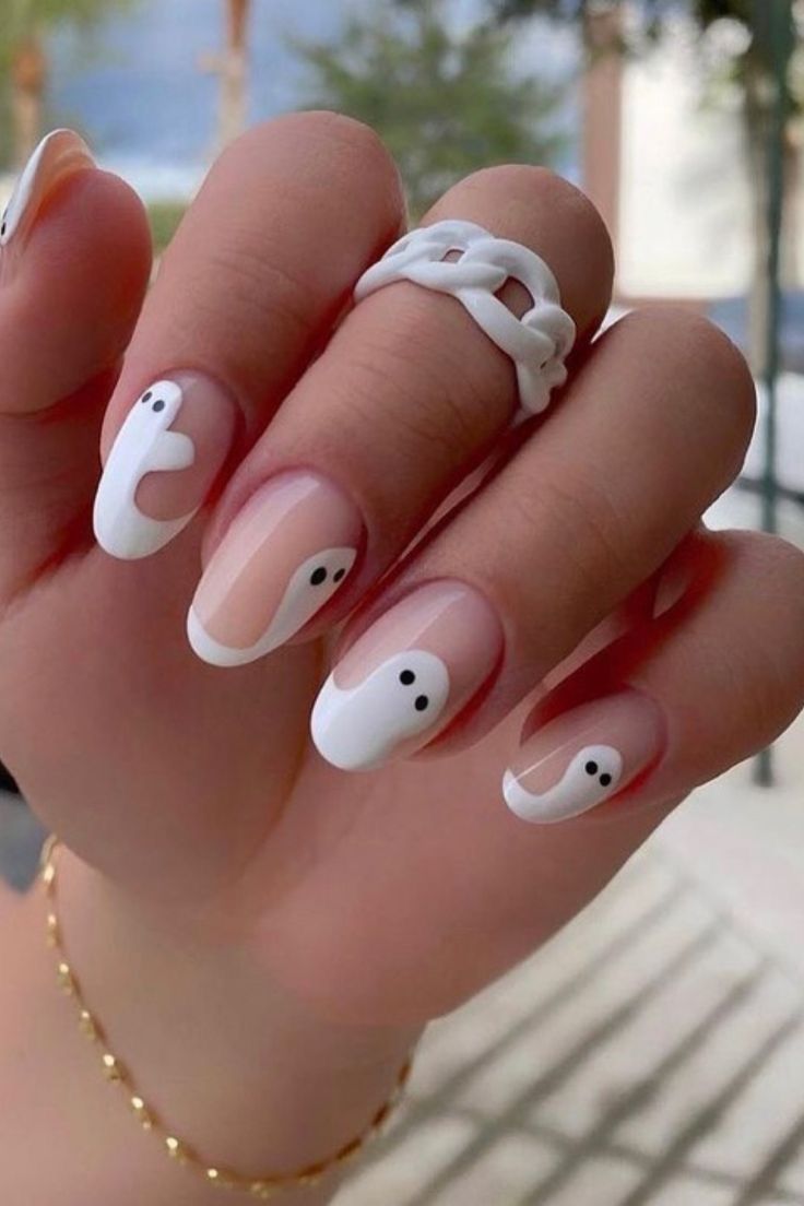 Chic Abstract Nail Design with White and Nude Colors Enhanced by Playful Black Dots.