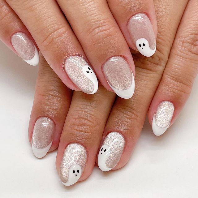 Whimsical Ghost-Themed Nail Design: Chic Sheer Glitter with Classic White Tips for Halloween.