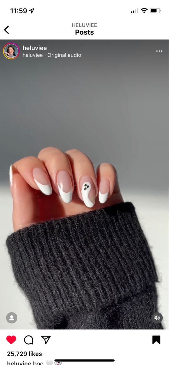 Chic Nail Design: Soft Pink and Bold White Tips with Playful Ghost Accents.