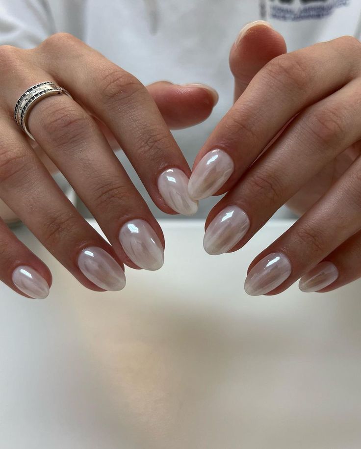 Chic Almond-Shaped Elegant Nude Nails with Glossy Finish and Subtle Tone Variations.