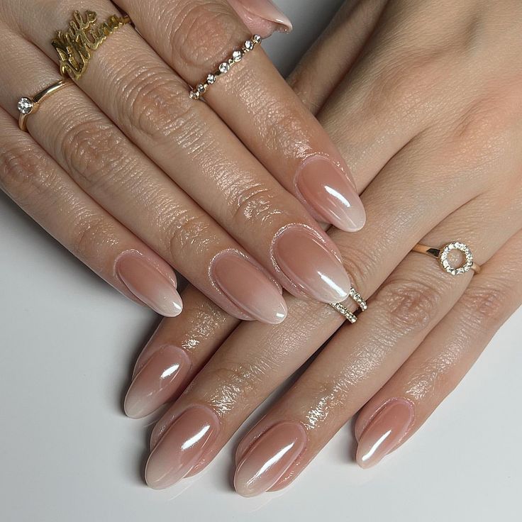 Chic Ombre Nail Design: Elegant Gradient from Nude to White with Polished Finish and Subtle Rings.