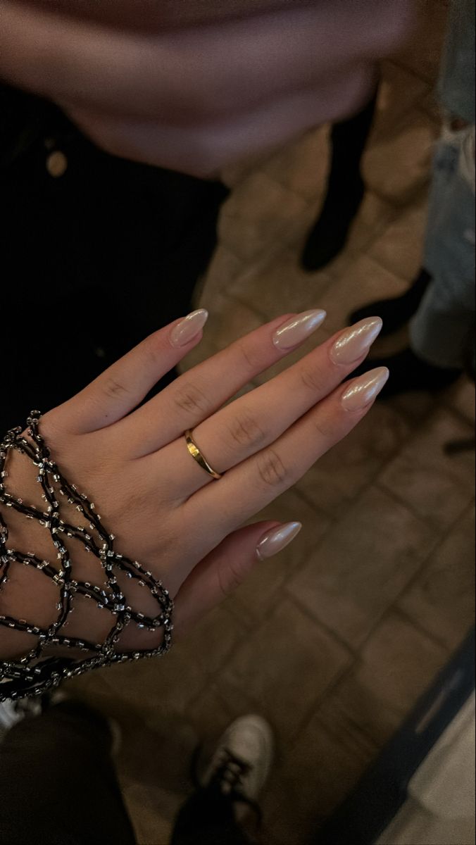 Chic Almond-Shaped Nails: Translucent Pink Polish with Sophisticated Accents.