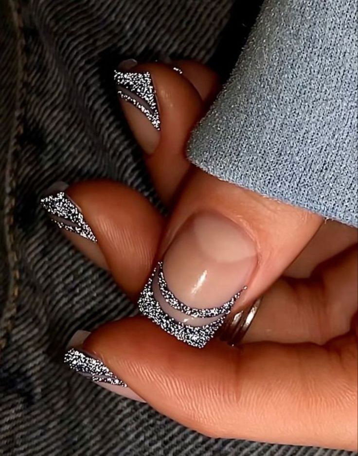 Chic Modern French Tip Nail Design with Silver Glitter on Nude Base.