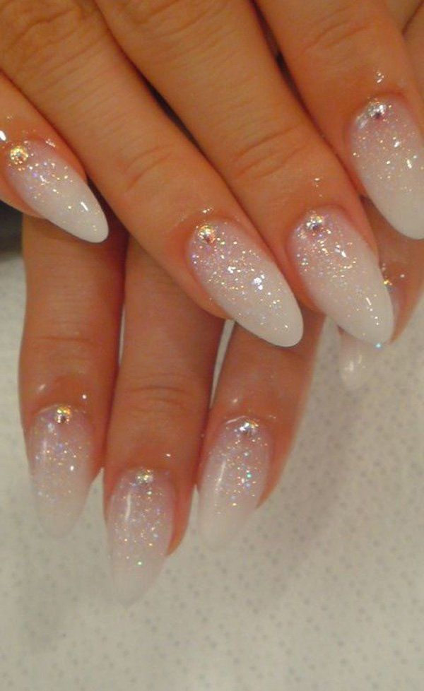 Enchanting Glitter Ombre Nails with Sparkles and Gem Accents.