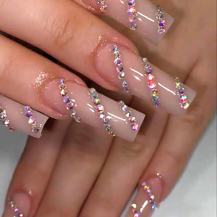 Glamorous Nude Nail Design Enhanced with Shimmering Rhinestones and High-Gloss Finish.