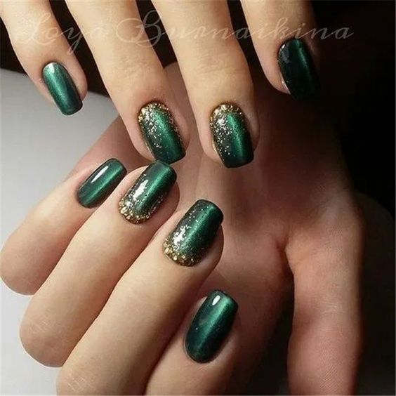 Elegant Dark Green Nails with Golden Accents for a Sophisticated Look.