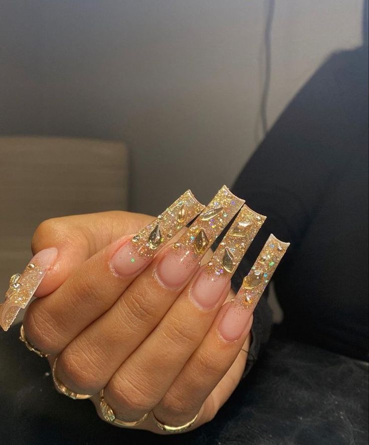 Glamorous Sparkling Acrylic Nails with Gold Glitter and Geometric Embellishments