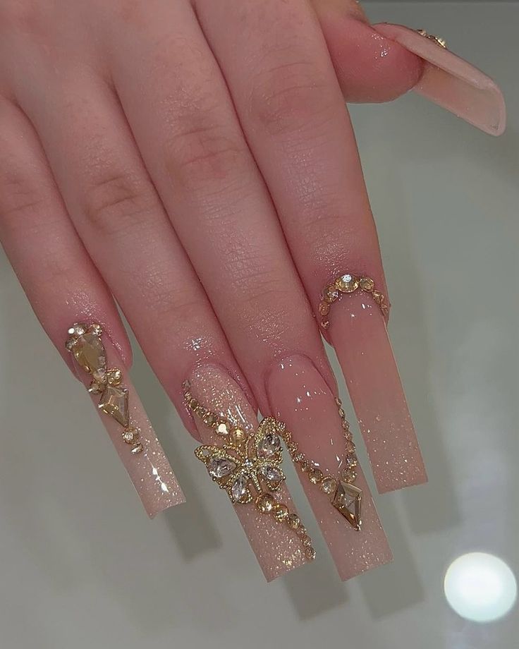 Sophisticated Nail Design with Elongated Tips, Shimmering Finishes, and Intricate Gold Embellishments.