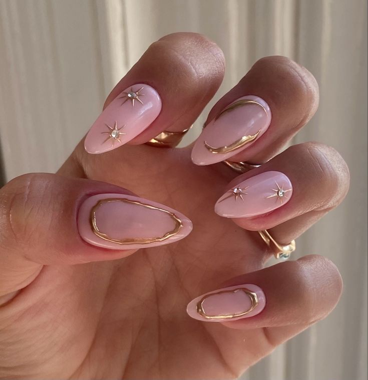 Sophisticated Glossy Pink Nails with Gold Outlines and Sparkling Star Accents.