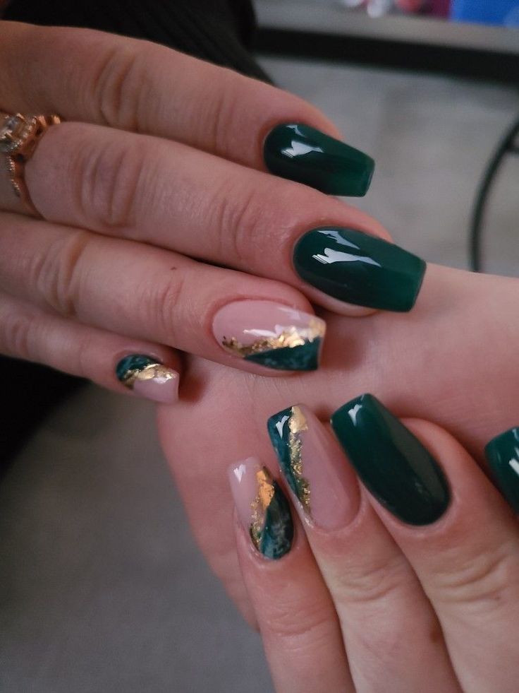 Luxurious Emerald Green and Nude Nail Design with Marbled Gold Accents