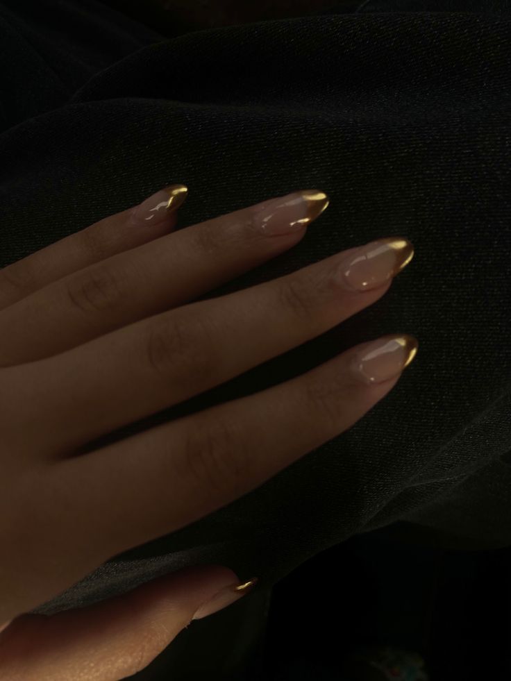 Sophisticated Nude and Gold Almond Nail Design for Understated Elegance.