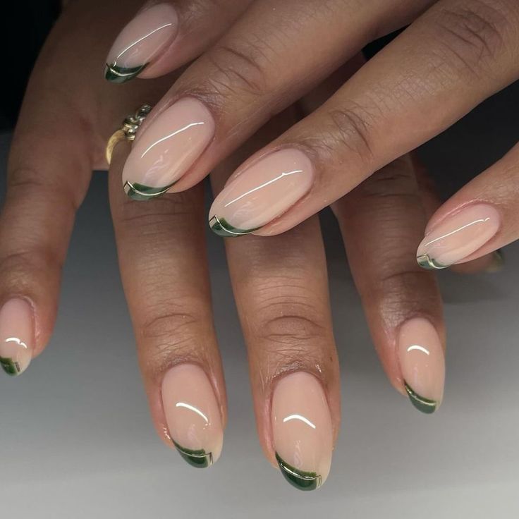 Sophisticated Nude Nails with Chic Green French Tips for a Modern Twist.