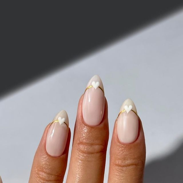 Charming Nude Nail Design with Heart Accents and Golden Lines