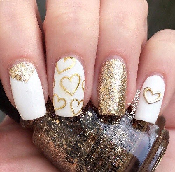 Elegant White and Sparkling Gold Chic Nail Design with Heart Patterns and Glitter Accents