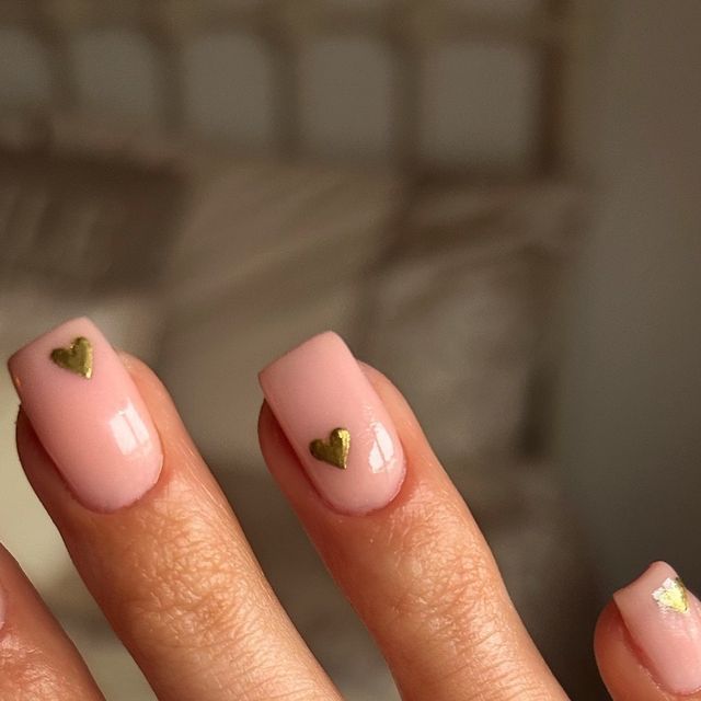 Elegant Chic Nail Design: Soft Pink Base with Gold Heart Accents