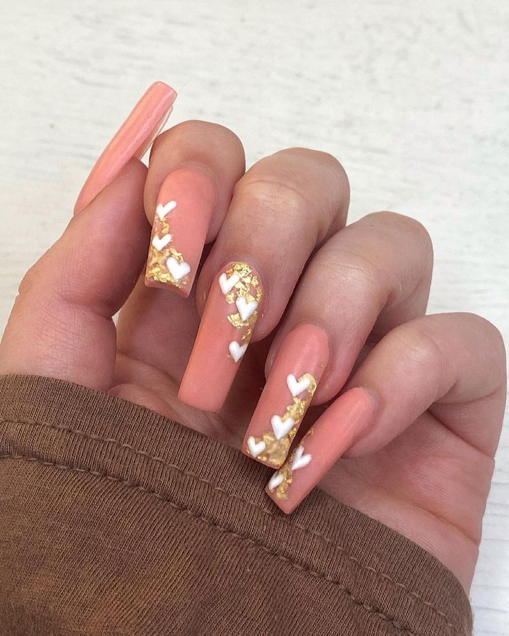 Elegant Peach Nail Design with Heart Accents and Gold Highlights