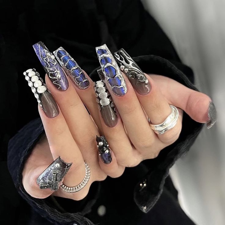 Chic Long Nails with Intricate Textures and Vibrant Color Combinations.