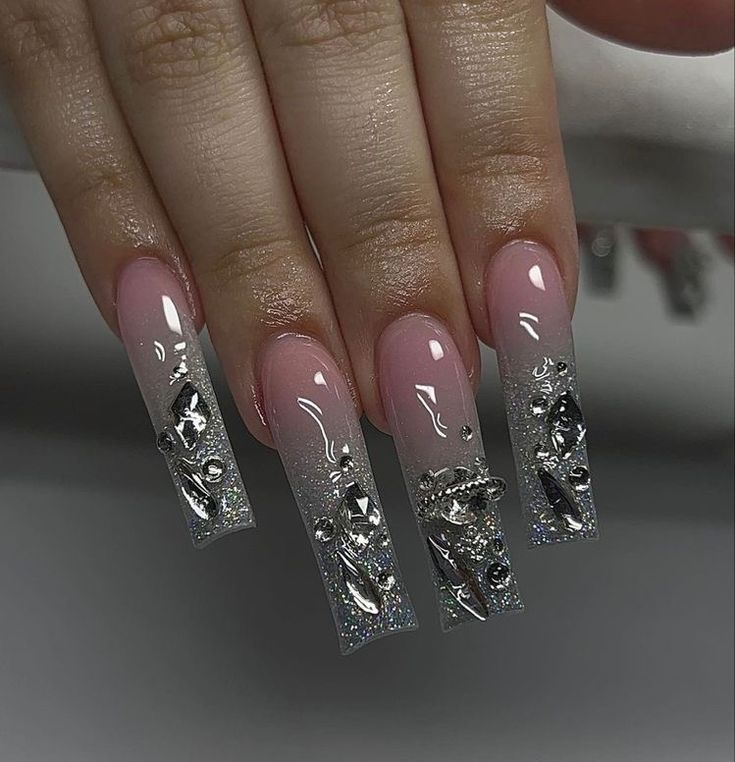 Chic Ombre Nail Design: Soft Pink Base with Sparkly Silver Tips and Glamorous Accents.