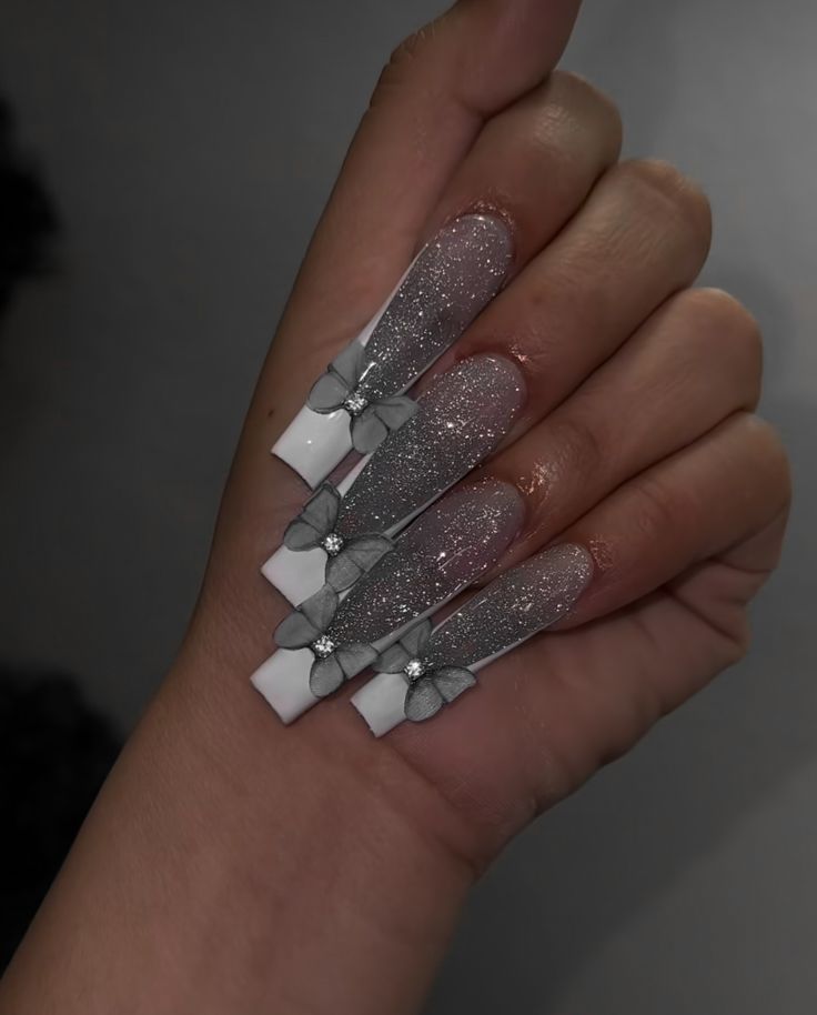 Glamorous Long Tapered Nail Design with Silver Gradient and Delicate Bow Accents.