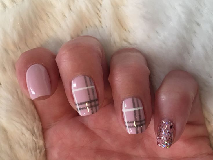 Elegant Pastel Pink Nail Design with Chic Plaid Accents and Sparkling Glitter.