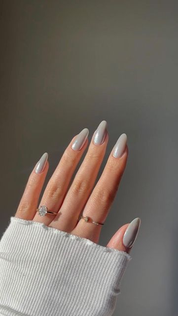 Sophisticated Almond-Shaped Nails in Muted Gray with Complementary Rings