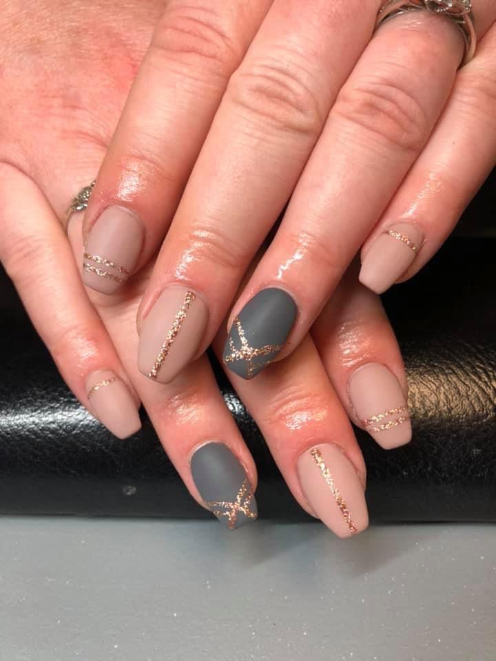 Sophisticated Chic Nail Design: Matte and Glossy Finishes in Muted Beige and Gray with Gold Accents.