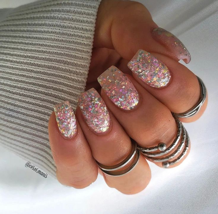 Chic Iridescent Glitter Nail Design with Elegant Elongated Square Shape and Minimalist Silver Rings.