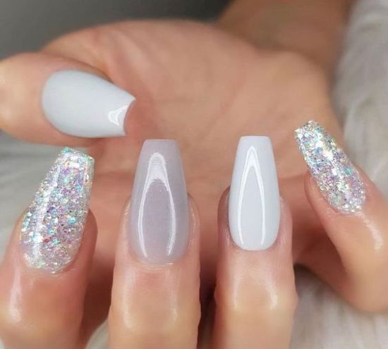 Sophisticated Soft Gray Nail Design with Iridescent Glitter Accents.