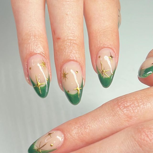 Chic Almond-Shaped Nails with Green French Tips and Gold Star Accents