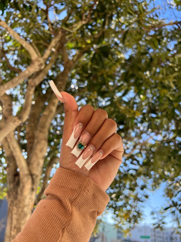 Sophisticated Elongated Square Nail Design with French Tips and Emerald Gem Accents.