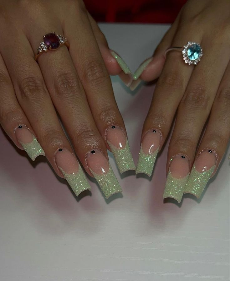 Glamorous Long Acrylic Nail Design with Gradient Effect and Glitter Accents.